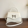 Elegant off-white small square handbag with silver bow buckle and top handle - White