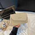 Beige faux leather and woven straw crossbody bag with gold text and thin shoulder strap - Off White