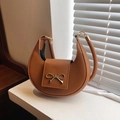 Brown half-moon handbag with gold bow ornament and textured synthetic leather finish - Yellow Brown