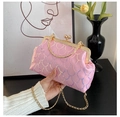 Detailed close-up of pink sequin evening bag with gold floral clasp and metal chain - Pink