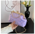 Detail view of purple sequin evening clutch with gold metal clasp and circular handle - Purple