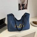 Borsa tote in denim blu scuro con ricamo Hello giallo e manici in pelle nera - Blu