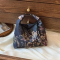 Elegant Xiangyun silk crossbody bag with dark floral prints and buckle handle detail - Green Peony Pattern