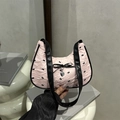 Pink seersucker underarm bag with black bow prints and a silver heart pendant - Pink