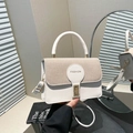 Elegant white and beige textured handbag with golden lock and crossbody strap - White