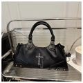 Sac à main gothique noir en cuir avec pendentif croix argentée et rivets sur une chaise - Noir