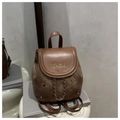 Detail of vintage mini backpack showing brown leather flap with gold brand embroidery - Brown