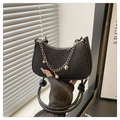 Detailed view of the black sparkling underarm bag with chain and pearl pendant. - Black
