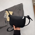 Minimalist black lychee pattern leather crossbody bag with decorative knots and zipper - Black