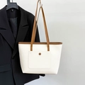 White pebbled leather tote bag with brown straps and functional front pocket - White