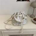 White bucket bag with black bow patterns, pearl handle and adjustable leather strap - White Bow