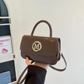 Brown patent leather handbag with gold M logo and slender shoulder strap for women - Brown