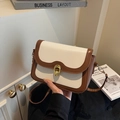 Retro cream and brown crossbody bag with gold ring buckle shown in a lifestyle setting - Off-white