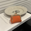 Mini orange leather jewelry pouch with lychee texture and gold metal snap clasp - Orange