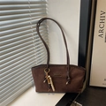 Brown suede tote bag with FASHION label and wooden bead charm in a minimalist interior - With Pendant / Brown