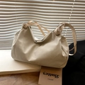 Minimalist cream-colored tote bag with smooth texture and adjustable shoulder strap - Off White