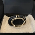 Elegant black oval clutch bag with large gold metal handle and shoulder chain strap - Black