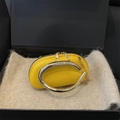 Bright yellow lychee leather clutch with architectural gold C-handle and chain strap - Yellow