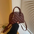 Deep red shell handbag with diamond quilting and gold hardware on an elegant background - Brown