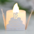 LED tea light candle with laser-cut paper lampshade featuring wedding cake silhouette - White