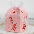 Pink laser-cut Christmas gift box with snowflake patterns and white ribbon bow - Pink