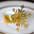 Elegant gold snowflake napkin ring on white dinner plate for Christmas table decor - Reflective Gold