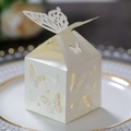 Elegant laser-cut cream butterfly gift box placed on a gold-rimmed white porcelain plate - Ivory