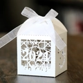 Macro detail of laser-cut 'CLASS OF 2024' graduation favor box with white ribbon bow - White