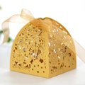 Golden laser-cut wedding favor box with floral patterns and a ribbon bow - Gold