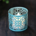 Light blue laser-cut mandala candle shade with warm LED glowing on a wood background - Tiffany Blue