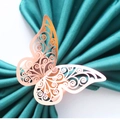 Elegant laser-cut hollow butterfly napkin ring in rose gold on a dark green silk background - Mirror Rose Gold