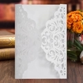 Elegant white laser-cut wedding invitations with intricate floral patterns for ceremonies - White