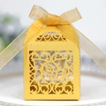 Golden laser-cut wedding favor box with rose patterns and shimmering ribbon bow - Gold