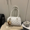 White quilted tote bag with dual shoulder straps and a plush brown bow charm - White