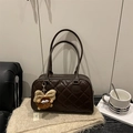 Fashionable dark brown quilted bowling bag with plush monster charm and shoulder straps - Brown