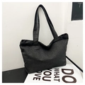Close-up of thick grey denim tote bag fabric texture with long shoulder straps - Black