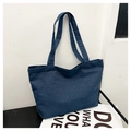 Detail view of deep blue denim tote bag with thick canvas texture and sturdy straps - Dark Blue