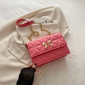Elegant pink quilted crossbody bag with gold bow clasp and chain shoulder strap - Pink
