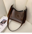 Detail of transparent brown PVC underarm bag with silver zipper and metallic hooks - Brown