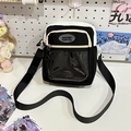 Black and white canvas crossbody bag with a large transparent PVC pocket and adjustable strap - Black