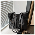 Detailed macro of black crackle effect tote bag featuring decorative drawstring laces - Black