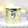Elegant laser cut golden heart napkin ring with vine patterns on a white tray - Reflective Gold