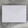 Elegant pearl white paper envelope with a classic triangle flap on a marble surface - Western Long Pearlescent