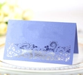 Close-up of laser-cut lavender wedding place card with intricate floral lace pattern - Sapphire Blue