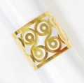 Elegant gold hollow napkin ring with geometric scroll patterns on white satin cloth - Reflective Gold