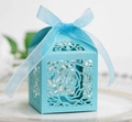 Sky blue laser-cut hollow rose candy box with silk ribbon bow on white ceramic plate - Turquoise Blue