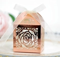 Elegant rose gold hollow candy box with floral laser cut design and white ribbon bow - Reflective Rose Gold
