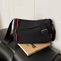 Black nylon crossbody bag with grid texture, red zipper accents and fashion label - Black