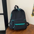 Minimalist black backpack with vibrant teal zipper accents and multi-pocket design - Black