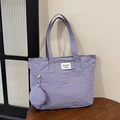 Bolso tote de nailon lila con monedero a juego y bolsillo frontal en mesa de madera - Bolso Púrpura (Incluye Bolso de Adorno) / Morado